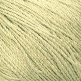 Close-up image of a ball of Gemstone Silk 2/12 yarn by Halcyon Yarn. The strands are tightly twisted together, creating a textured and detailed pattern. The soft light yellow color and fibrous material convey a sense of warmth and softness, perfect for knitting cozy garments.