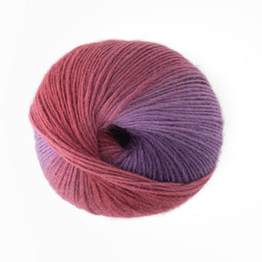 A ball of Louisa Harding Amitola Grande yarn by Knitting Fever / Euro Yarns, featuring a gradient from deep pink to purple with a spiral twist, is positioned against a plain white background.