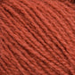 A close-up view of Halcyon Yarn's Victorian 2-Ply Wool Yarn in rust color. The fibers intertwine to create a soft and warm appearance, ideal for hand knitting or crocheting projects. The Sport weight yarn's fluffy texture and rich color are prominently displayed in the image.