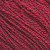 Close-up of Halcyon Yarn's Victorian 2-Ply Wool Yarn, showcasing the soft, fibrous texture and twisted strands. The sport weight wool appears thick and slightly fuzzy, with a rich, deep red color perfect for hand knitting.