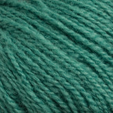 Close-up of Victorian 2-Ply Wool Yarn fibers in green from Halcyon Yarn. The texture appears soft and slightly fuzzy, with intertwined strands creating a dense, intricate pattern. This Sport weight wool has a light sheen and a consistent green color throughout, making it perfect for hand knitting projects.