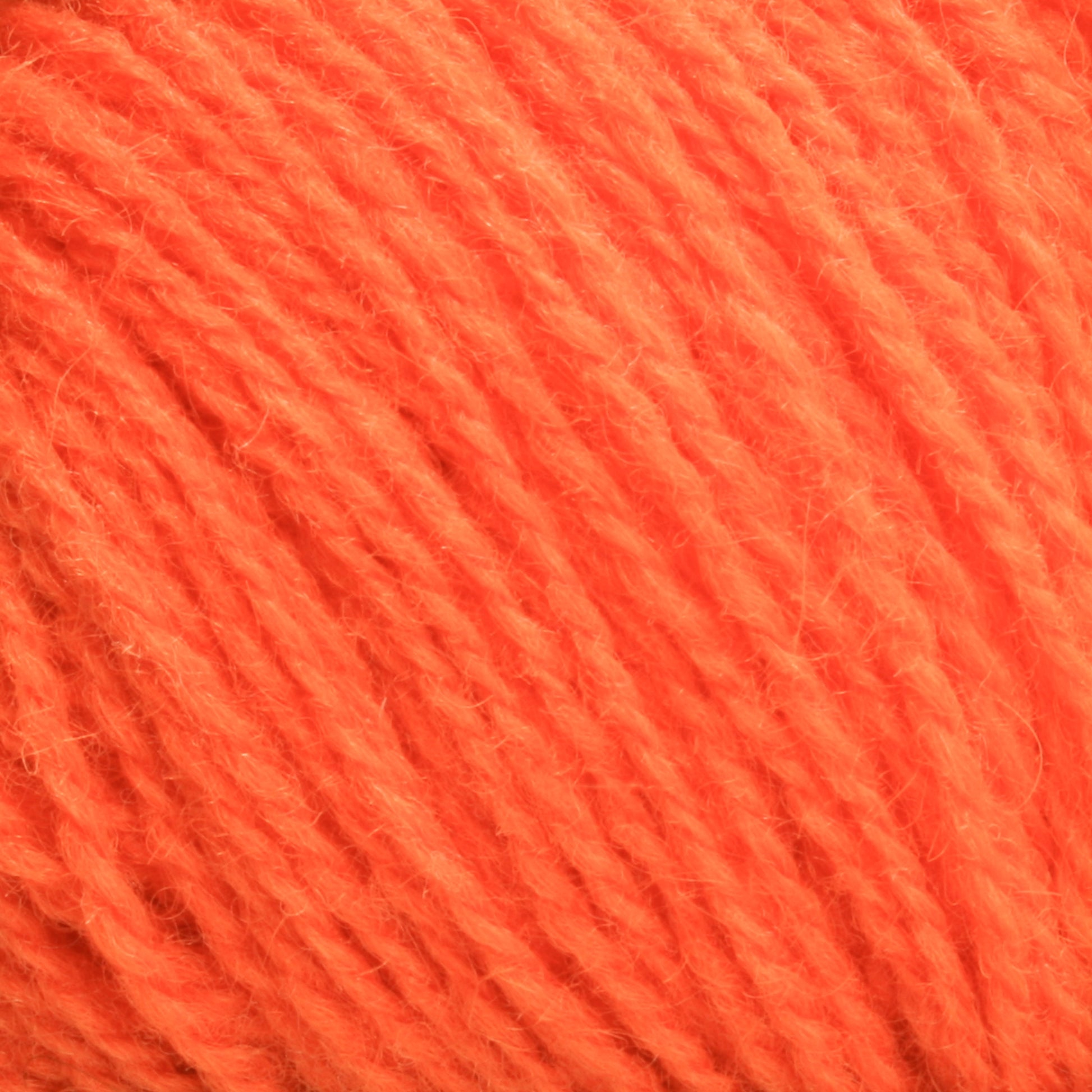 Close-up view of a ball of Victorian 2-Ply Wool Yarn in bright orange, sport weight with a slightly fuzzy texture, showing the individual strands interwoven together—perfect for hand knitting. This exquisite yarn is brought to you by Halcyon Yarn.