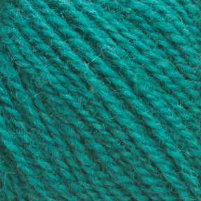 Close-up view of Victorian 2-Ply Wool Yarn fibers in an intricate teal sport weight weave, by Halcyon Yarn. The soft and slightly fuzzy texture of the vibrant teal strands makes this yarn ideal for hand knitting projects.