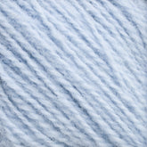 Close-up image of Halcyon Yarn's Victorian 2-Ply Wool Yarn in a soft, light blue color. The fibers are slightly fuzzy, giving a textured and cozy appearance. This sport weight yarn appears tightly twisted and is perfect for hand knitting or crocheting projects.