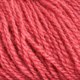 Close-up view of soft, pink Victorian 2-Ply Wool Yarn strands woven together, showcasing their texture and fibrous details. The image highlights the delicate fibers and intricate twists of this Halcyon Yarn hand knitting material.