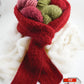 A variety of colorful yarn balls are nestled in Halcyon Yarn's Sophisticated Weekend Scarf. The scarf is arranged neatly around them. White fluffy material surrounds the scarf, and an Adobe PDF document icon appears at the bottom of the image, adding a touch of modernity to this Victorian Boucle scene.