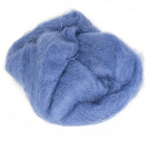 A bundle of soft, fluffy Victorian Brushed Mohair Yarn in a light blue color, loosely gathered in a slightly tangled pile, reminiscent of luxurious yarn from Caledonian Dye Works.