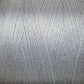 Close-up image of a spool of light gray 8/2 Tencel Yarn from Maurice Brassard. The tightly woven, thin threads create a smooth texture. The surface showcases a uniform, slightly shiny appearance, perfect for weaving projects and knitting accessories, highlighting the fine details of the individual strands.