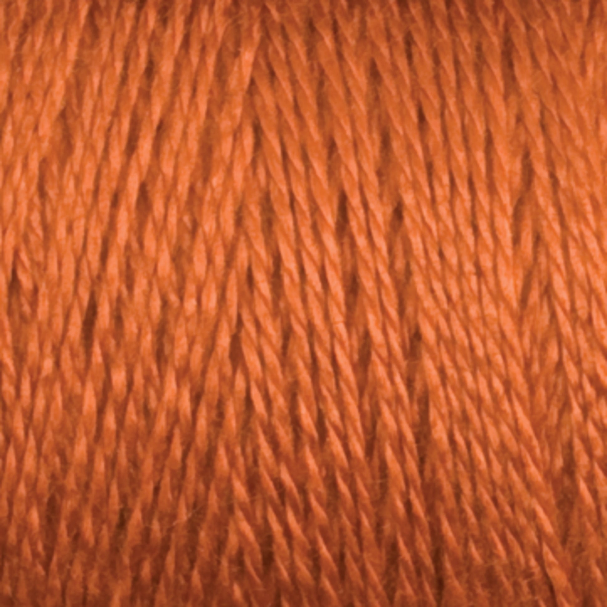 Close-up view of a spool of Maurice Brassard 8/2 Tencel Yarn | Tube in brown, showcasing its smooth, slightly glossy texture. The individual strands are tightly wound together, creating a uniform appearance—perfect for weaving projects or knitting accessories.