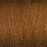 A close-up view of Maurice Brassard’s 8/2 Tencel Yarn in brown, showcasing its texture and tightly woven fibers. The yarn has a smooth appearance with slight variations in shade, emphasizing the natural look of the material—a perfect choice for your weaving projects.