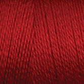 Close-up image of a spool of Maurice Brassard 8/2 Tencel Yarn | Tube in red, showing the tightly wound strands. Ideal for weaving projects, the texture and vibrant color of this Tencel yarn are clearly visible.