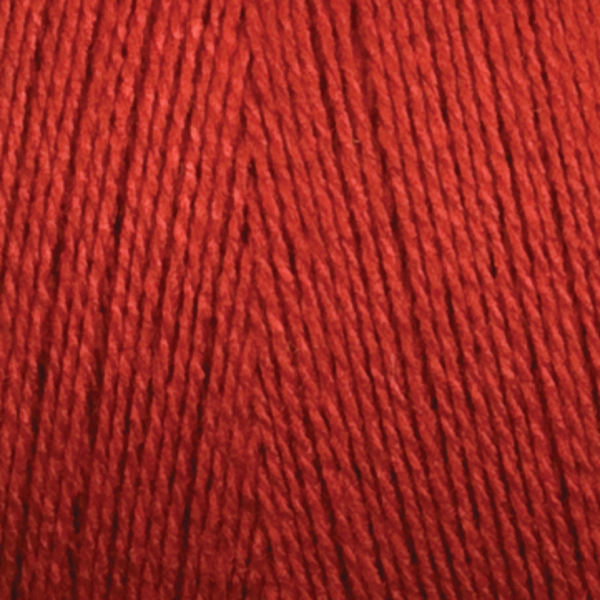 Close-up image of Maurice Brassard 8/2 Tencel Yarn | Tube in red, highlighting the texture and carefully wound fibers. The yarn strands are parallel and tightly packed together, creating a uniform and smooth surface—perfect for knitting accessories or weaving projects.