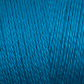 Close-up image of blue 8/2 Tencel Yarn | Tube by Maurice Brassard, showcasing tightly woven strands that create a textured and slightly glossy surface. The yarn appears smooth and uniform in color, with the strands running vertically across the frame—perfect for weaving projects or as a staple in knitting accessories.