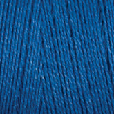 Close-up image of vibrant blue 8/2 Tencel Yarn | Tube by Maurice Brassard, revealing the texture and tightly twisted fibers. The yarn looks smooth with subtle tone variations due to the lighting, giving it a rich and slightly shiny appearance. Perfect for weaving projects or other knitting accessories.