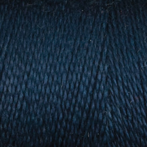 Close-up of Maurice Brassard's 8/2 Tencel Yarn in dark blue, showcasing its tightly wound texture and subtly varied shades. The fibrous surface makes it perfect for weaving projects or a great addition to your knitting accessories collection.