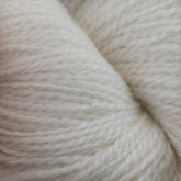 Close-up of a skein of the soft, cream-colored Herriot Fine Alpaca by Juniper Moon Farm yarn from Knitting Fever / Euro, showcasing its tightly spun fibers with impressive texture and detail. This Baby alpaca yarn appears cozy and perfect for knitting sumptuous socks or lightweight accessories.