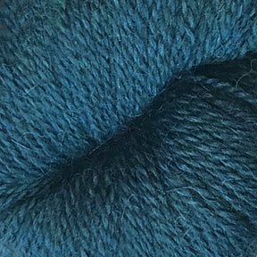 A close-up image of Herriot Fine Alpaca by Juniper Moon Farm from Knitting Fever / Euro, showcasing its soft and fluffy teal-colored yarn with visibly fine fibers interwoven. The tightly spun yarn displays varying shades of teal, with subtle hints of lighter and darker threads intermingled throughout, making it perfect for lightweight accessories.