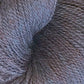 Close-up image of a skein of Herriot Fine Alpaca by Juniper Moon Farm from Knitting Fever / Euro, showcasing its soft, multi-toned gray texture. The dense and slightly fluffy fibers suggest it's made from baby alpaca, making it ideal for creating cozy, warm materials suitable for knitting or crocheting lightweight accessories.