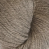 Close-up image of a skein of light brown Herriot Fine Alpaca yarn by Juniper Moon Farm, showcasing its texture and tightly twisted strands. The Herriot Fine Alpaca by Knitting Fever / Euro, crafted from Baby alpaca, appears soft, thick, and ideal for knitting or crocheting sumptuous socks.