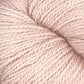 Close-up image of a skein of Herriot Fine Alpaca by Juniper Moon Farm yarn in soft, light pink. The individual strands are tightly twisted together, creating a smooth, even texture. This luxurious yarn from Knitting Fever / Euro is perfect for knitting or crocheting sumptuous socks and lightweight accessories.