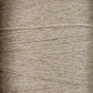 Close-up view of tightly wound beige Newport 16/2 Linen Yarn, showing the texture and fine fibrous strands. The yarn appears slightly rough, with varying thickness and a natural, rustic appearance reminiscent of woven items from Halcyon Yarn's collection.