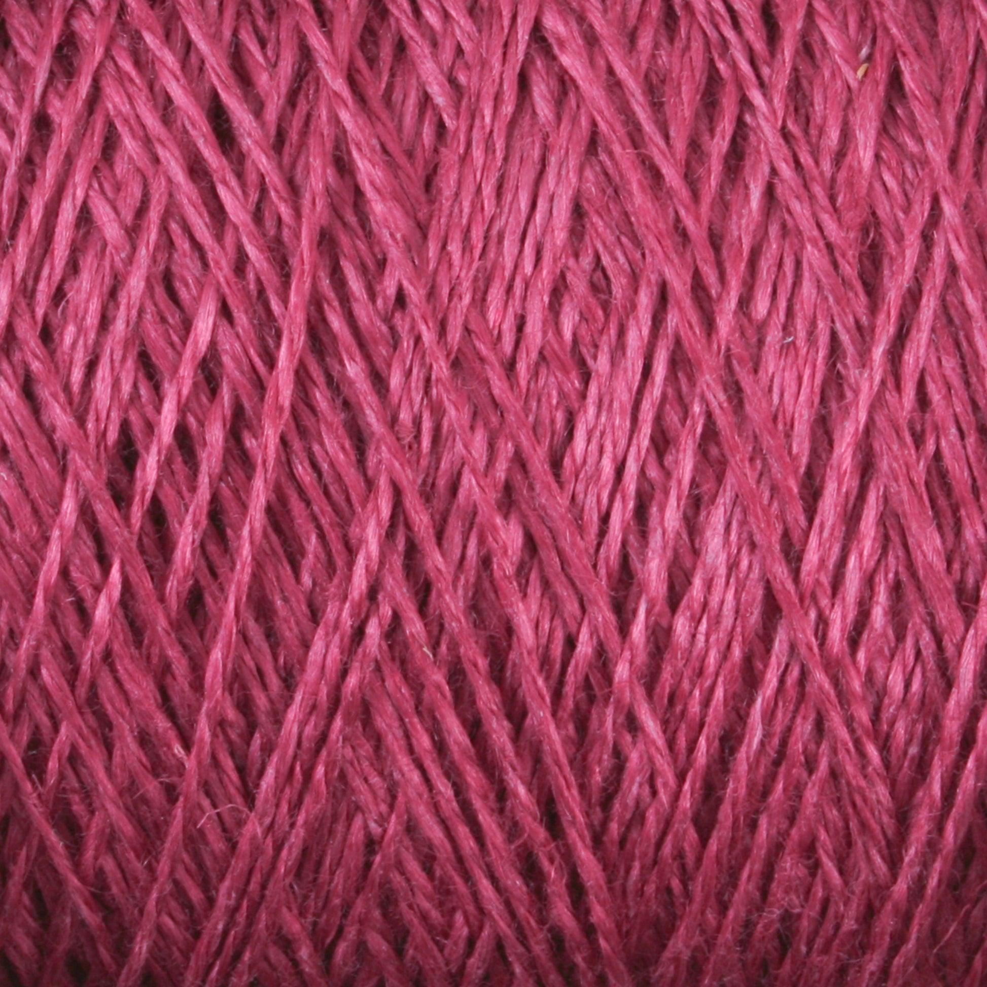 Close-up image of a skein of Newport 16/2 Linen Yarn | Mini-cone by Halcyon Yarn, showcasing the detailed texture and individual threads winding around each other tightly. The fibers appear soft, smooth, and glossy, highlighting the intricate pattern and consistency of the yarn.