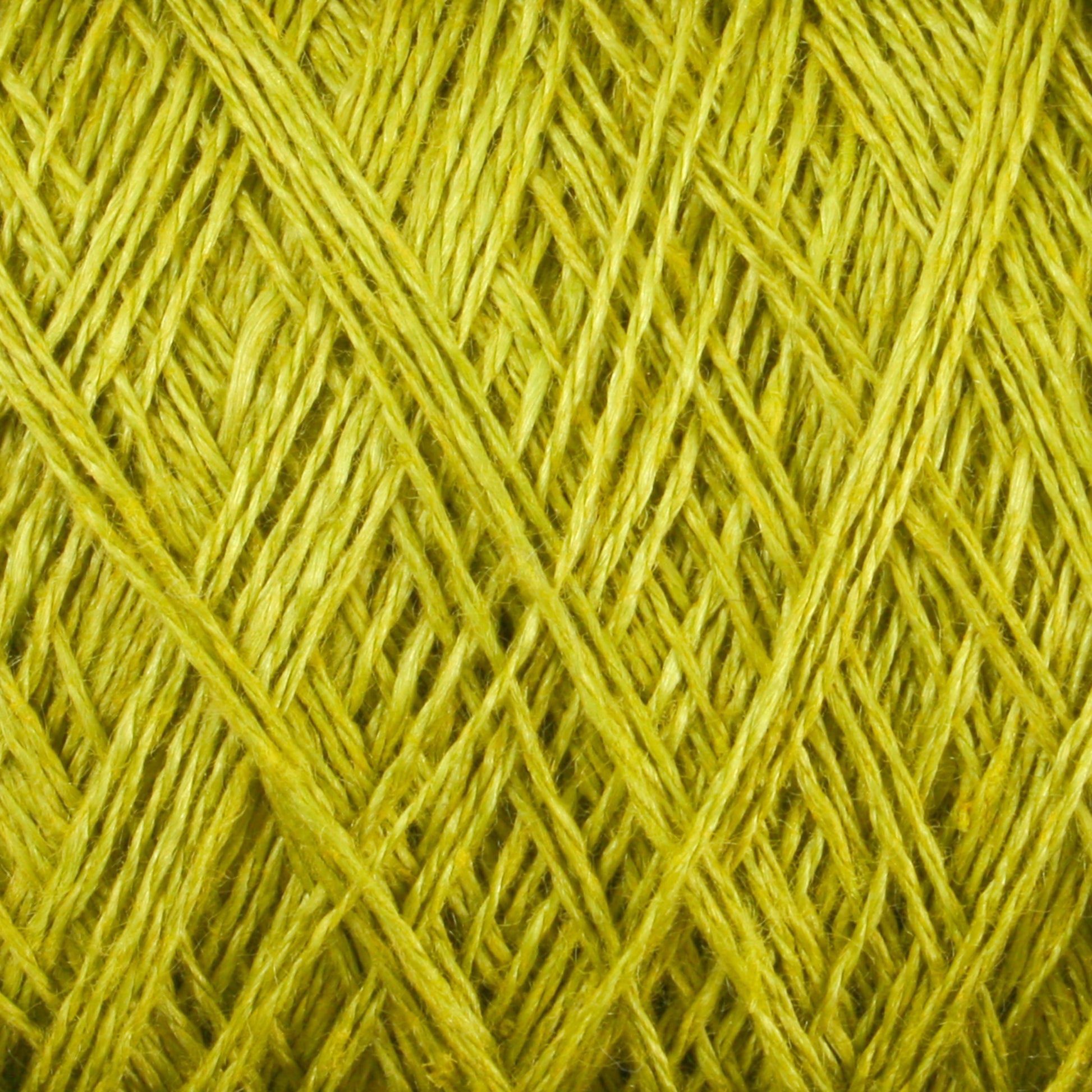 Close-up image of intricate, crisscrossing threads of bright yellow-green Newport 16/2 Linen Yarn | Large Cone by Halcyon Yarn, creating a textured and detailed pattern. The fibers appear slightly glossy and tightly wound together, forming an intricate web of overlapping lines.