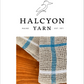 Halcyon Yarn label featuring the Classic Linen Dishcloths, Weaving Kit (Rigid Heddle). These dishcloths are crafted with a canvas weave and adorned with blue-white stripes against a wooden background. Ideal kitchen accessories since 1971.