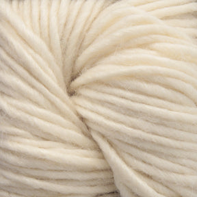 A close-up of a bundle of thick, soft, ivory-colored Moonshine yarn by Juniper Moon Farm from Knitting Fever / Euro, showcasing the texture and twisting strands.