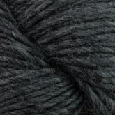 Close-up of a bundle of Moonshine by Juniper Moon Farm yarn from Knitting Fever / Euro. The wool strands are tightly coiled together, exhibiting a slightly fuzzy texture. The dark green color is consistent throughout the yarn, with subtle variations in the fibers.