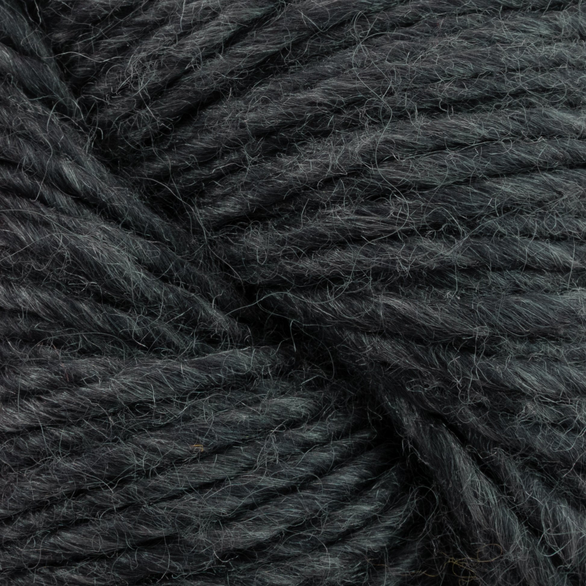 Close-up of a bundle of Moonshine by Juniper Moon Farm yarn from Knitting Fever / Euro. The wool strands are tightly coiled together, exhibiting a slightly fuzzy texture. The dark green color is consistent throughout the yarn, with subtle variations in the fibers.