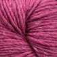 Close-up image of Moonshine by Juniper Moon Farm yarn, showing the detailed texture and intertwined fibers. The yarn, made from a luxurious blend of silk and alpaca, appears to be soft and slightly fuzzy, with a rich, vibrant pink color. This exquisite product is offered by the brand Knitting Fever / Euro.