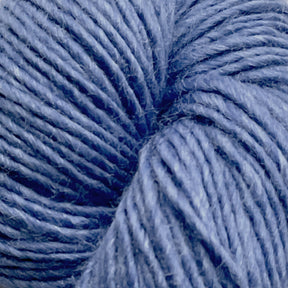 A close-up image of a skein of Moonshine by Juniper Moon Farm alpaca yarn in a vivid blue hue. The strands are tightly wound together, showcasing their soft and slightly fuzzy texture. The image emphasizes the intricate details and fibers of the yarn, highlighting its smooth and uniform appearance. This premium product is brought to you by Knitting Fever / Euro.