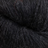 A close-up of Juniper Moon Farm Herriot Baby Alpaca yarn by Knitting Fever / Euro, highlighting its fibrous and slightly fuzzy texture. Hints of lighter-colored fibers are intertwined, creating a subtle contrast within the DK weight yarn. The image focuses on the intricate details of the extrafine baby alpaca strands.