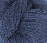 Close-up image of dark blue extrafine baby alpaca yarn. The DK weight fibers are tightly twisted together, creating a thick and textured appearance. The overall image highlights the softness and detail of the individual fibers, showcasing the luxurious quality of Juniper Moon Farm Herriot Baby Alpaca by Knitting Fever / Euro.