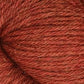 Close-up of a skein of reddish-brown Juniper Moon Farm Herriot Baby Alpaca yarn from Knitting Fever / Euro, showcasing the texture and individual strands twisted together in a soft and slightly fuzzy appearance. This DK weight yarn boasts a warm, earthy hue with subtle variations in tone.