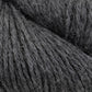 Close-up image of charcoal gray Juniper Moon Farm Herriot Baby Alpaca yarn from Knitting Fever / Euro showing fine fibers and soft texture. The DK weight yarn is densely packed, with individual strands visible, highlighting its thick and cozy appearance, suitable for knitting or crocheting projects.