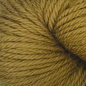 Close-up of a skein of Juniper Moon Farm Herriot Baby Alpaca yarn in a golden yellow color. The texture of the DK weight yarn is visible, showcasing tightly spun fibers and a soft, wool-like appearance reminiscent of extrafine baby alpaca from Knitting Fever / Euro.