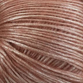 Close-up image of a ball of soft, glossy Katia Air Lux fingering weight yarn in a rose pink color. The Merino wool is intricately wound, with a shiny, silky texture that catches the light. The image highlights the fine threads and smooth surface of this premium yarn from Knitting Fever / Euro.