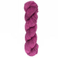 A skein of Malabrigo Lace from Malabrigo Yarn in vibrant magenta, twisted neatly against a white background, inspires thoughts of delicate knitted shawls crafted from fine lace weight merino.