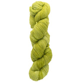 A twisted skein of Malabrigo Lace yarn in a vibrant light green hue is displayed against a simple white backdrop. This soft and smooth lace weight yarn, made from merino by Malabrigo Yarn, is ideal for crafting exquisite knitted shawls and other delicate projects.