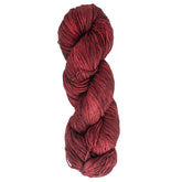 A skein of Malabrigo Sock made by Malabrigo Yarn, featuring deep red, kettle-dyed superwash merino wool with a tight twist that highlights subtle color variations against a white background.