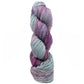 A twisted skein of Malabrigo Arroyo, a variegated merino wool yarn by Malabrigo Yarn, in shades of purple, lavender, and light blue, isolated against a white background.