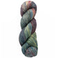 A skein of Malabrigo Arroyo by Malabrigo Yarn, a multicolored sport weight yarn, features a palette with shades of blue, green, pink, and gray. Tightly twisted into a cylindrical shape and crafted from superwash merino wool, it offers a soft and smooth texture with seamlessly blending colors for a variegated effect.