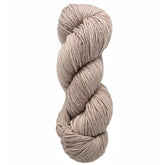 An intricately twisted skein of Malabrigo Arroyo, a thick, light beige yarn from Malabrigo Yarn, crafted from merino wool and showcased on a plain white background. The yarn exhibits a soft, textured appearance, perfect for knitting or crocheting projects.