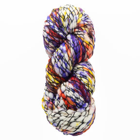 The Malabrigo Caracol by Malabrigo Yarn is a super bulky skein crafted from soft merino wool, featuring a blend of white, purple, yellow, red, and black. This yarn showcases a textured appearance with both vibrant and muted tones seamlessly swirling together in a kettle-dyed finish.