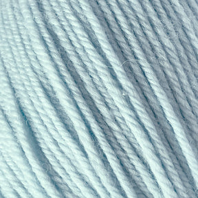 Close-up image of soft, light blue yarn in tight, parallel strands. The texture appears fluffy and smooth, suitable for knitting or crocheting projects. This Cascade 220 Superwash Wool Yarn by Cascade Yarns is made from 100% merino wool, offering beautiful stitch definition in a DK weight. Lighting highlights the subtle variations in the fibers, showcasing its softness and color.