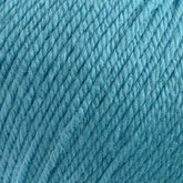 Close-up image of a ball of Cascade 220 Superwash Wool Yarn from Cascade Yarns. The 100% merino wool strands are tightly wound together, showcasing the texture and fibers. The image emphasizes the rich color and beautiful stitch definition of this superwash DK weight yarn.