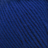 Close-up image of Cascade 220 Superwash Wool Yarn by Cascade Yarns in deep blue, wound into a ball. The 100% merino wool strands are tightly woven together, creating a textured, fibrous surface that boasts beautiful stitch definition.