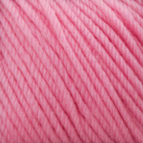 A close-up image of Cascade 220 Superwash Wool Yarn fibers in a vibrant pink hue reveals the texture of the DK weight, 100% merino wool. The soft, twisted strands are tightly knit, showcasing excellent stitch definition and creating a cozy, warm appearance.